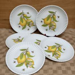Set of white paper plates with lemon and bee designs