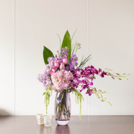 Pink and purple floral arrangement in a glass vase