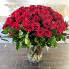 Large bouquet of red roses in a clear glass vase