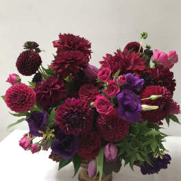 Bouquet of burgundy, pink, and purple flowers in a vase