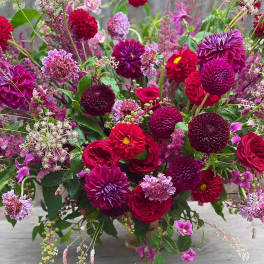 Large bouquet of magenta, red, and pink flowers