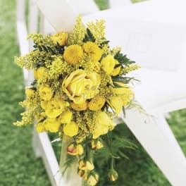 Yellow floral bouquet tied to a white chair