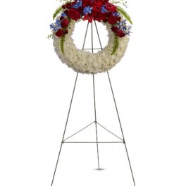 Standing funeral wreath with red and white flowers on an easel