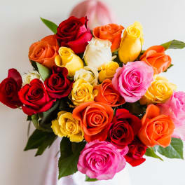 Bouquet of multicolored roses with a pink ribbon