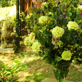Tall mixed flower arrangement in a clear glass vase