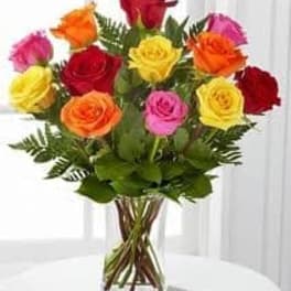 Bouquet of multicolored roses in a clear glass vase