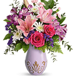 Pink lilies and roses in a lavender vase