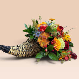 Horn-shaped basket filled with colorful flowers and berries