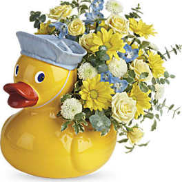 Yellow duck-shaped vase with yellow and blue flowers