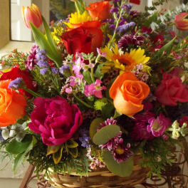 Colorful mixed flower arrangement in a wicker basket