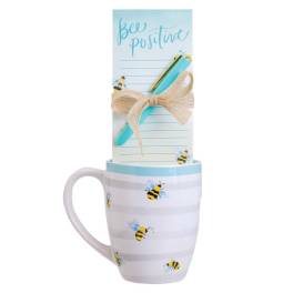 Bee-themed mug with a notepad and pen tied on top