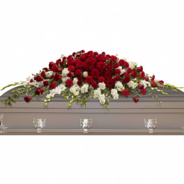 Red and white floral spray on a casket