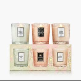 Set of three scented candles in frosted glass holders with pastel packaging