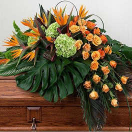 Tropical floral casket spray with orange roses and green hydrangeas