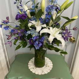 Blue and white floral arrangement in a glass vase