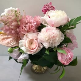 Pink and white floral arrangement in a small vase