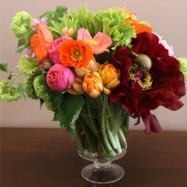 Colorful bouquet of mixed flowers in a clear glass vase