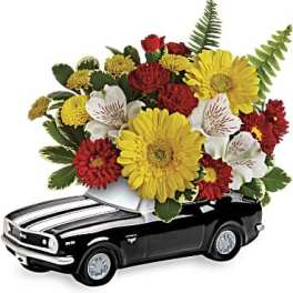 Black toy car topped with a colorful flower arrangement