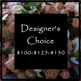 Pink and white roses arranged around a black sign with pricing text.
