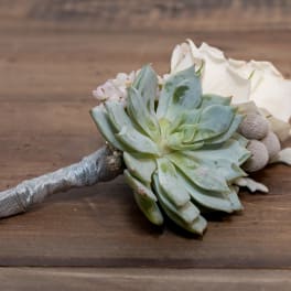 Succulent bouquet with white roses and a silver wrapped handle