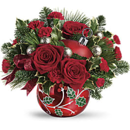 Red roses and carnations in a decorated red vase