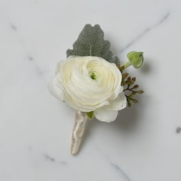 White ranunculus boutonniere with a ribbon-wrapped stem