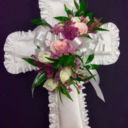 White satin cross with pink and white flowers