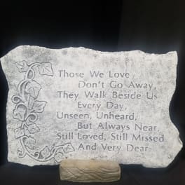Engraved memorial stone with a floral vine design and sympathy quote