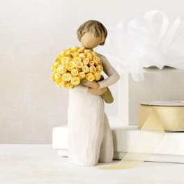 Figurine of a bride holding a yellow rose bouquet