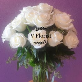 White rose bouquet in a clear glass vase