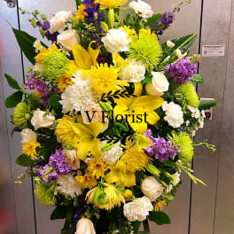 Standing floral spray with yellow, white, and purple flowers