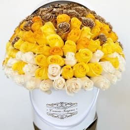 Bouquet of yellow, white, and bronze roses in a white hat box