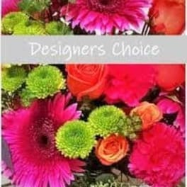 Bright mixed bouquet with pink gerbera daisies, orange roses, and green pompons