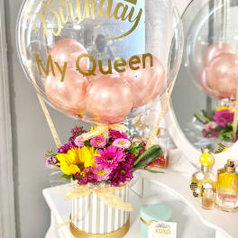 Birthday balloon with pink flowers in a striped box