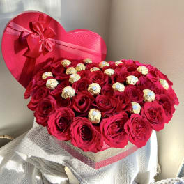 Heart-shaped box of red roses with gold-wrapped chocolates