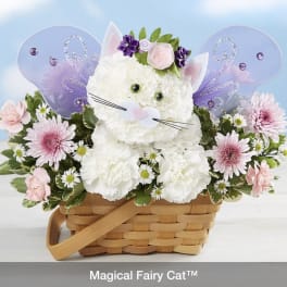 White floral cat arrangement in a wicker basket with purple fairy wings
