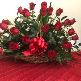 Basket of red roses with a red ribbon bow