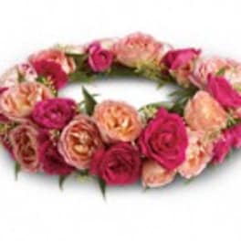 Pink and peach rose floral crown on a white background