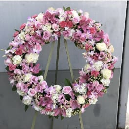 Pink and white floral wreath on an easel