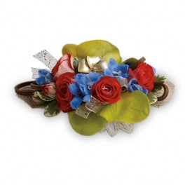 Arrangement of red roses and blue flowers with green petals