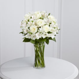 White rose bouquet in a clear glass vase
