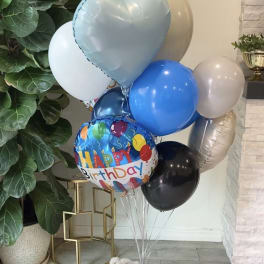 Birthday balloon bouquet with a teddy bear and chocolates