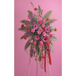 Tall pink and red floral arrangement with ribbon streamers