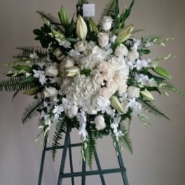 Large white floral standing spray on an easel