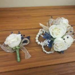 White rose corsage and matching boutonniere with pearl accents