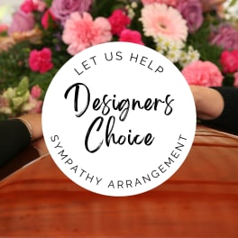 Mixed pink and white flowers behind a "Designers Choice" sympathy sign