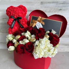 Red rose teddy bear and mixed roses in a heart-shaped gift box