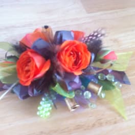 Small bouquet of orange roses with decorative beads and ribbon