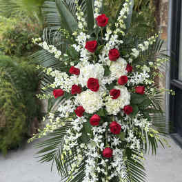 Tall floral spray with red roses and white flowers