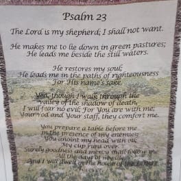 Fringed wall hanging with Psalm 23 text over a pastoral scene